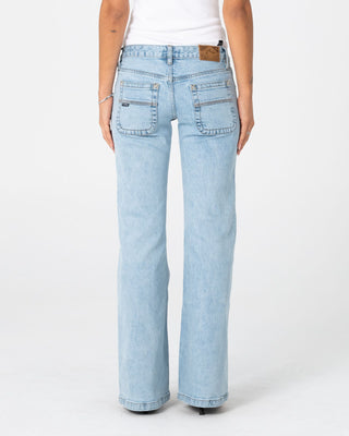Woman wearing Freida Flare Low Rise Jeans 2.0 in True Blue