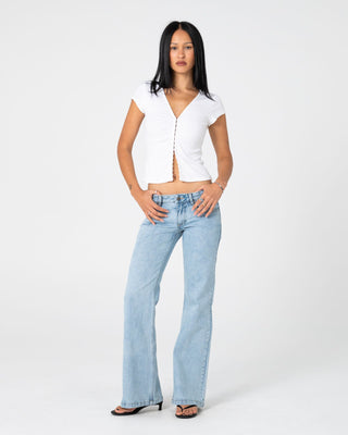 Woman wearing Freida Flare Low Rise Jeans 2.0 in True Blue