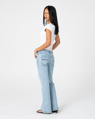 Woman wearing Freida Flare Low Rise Jeans 2.0 in True Blue