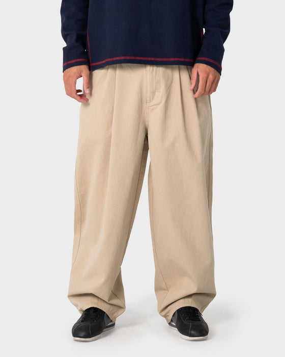 man-wearing-enigma-pleated-pant-in-abbey-stone