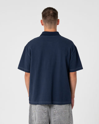 Man wearing Blinker Short Sleeve Polo in Navy Blue