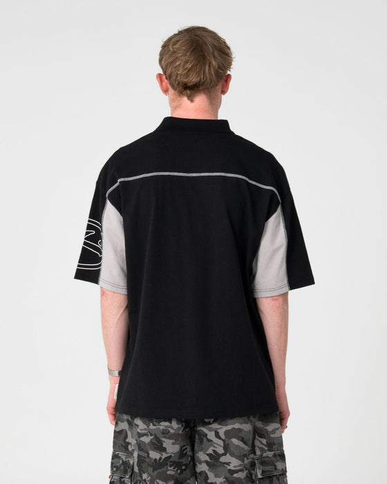 man-wearing-cyberwave-short-sleeve-polo-in-black