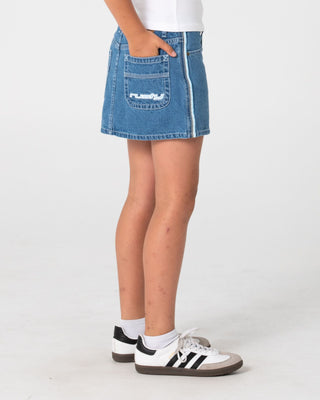 Girl wearing Flip Girl Mini Denim Skirt in Middy Blue / Blue