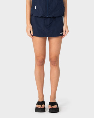 Woman wearing Lombardi Nylon Mini Skirt in Navy Blue / White