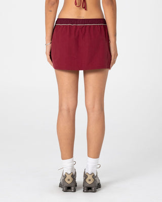 Woman wearing Breezy Wind Cheater Mini Skirt in Cranberry