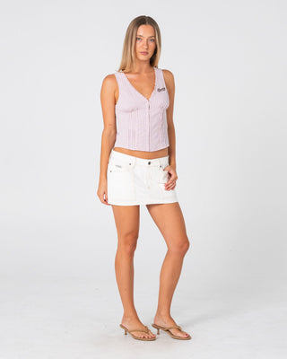 Woman wearing Work It Low Rise Mini Denim Skirt in Snowy White