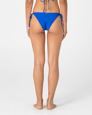 Woman wearing Shadow Midi Side Ties Bikini Bottom in Cobalt Blue