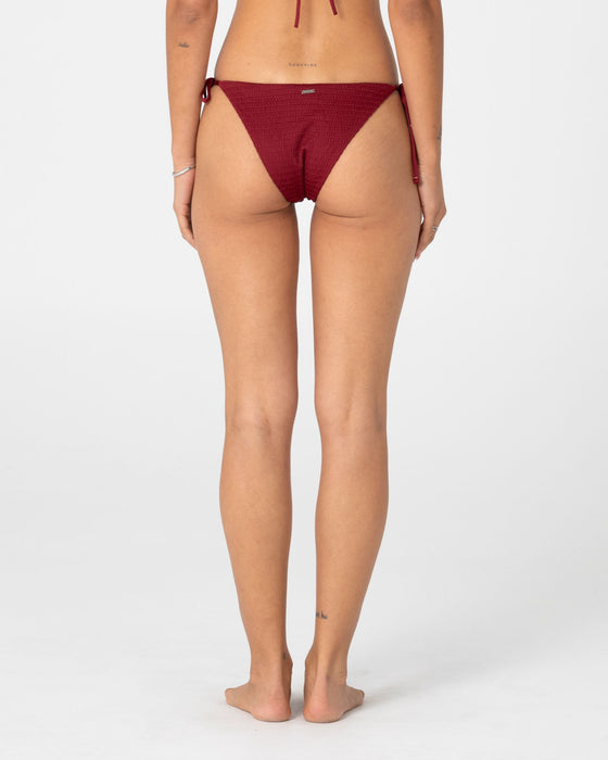 woman-wearing-cedar-midi-side-ties-bikini-bottom-in-cranberry