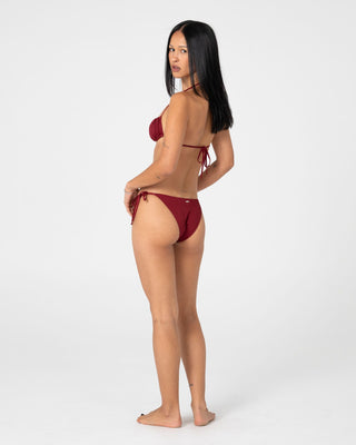 woman-wearing-cedar-midi-side-ties-bikini-bottom-in-cranberry