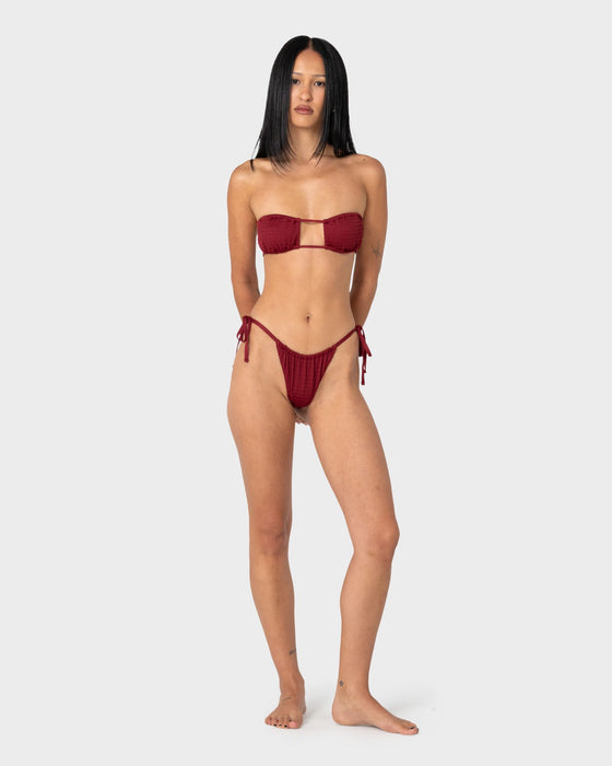 woman-wearing-cedar-bandeau-open-front-bikini-top-in-cranberry