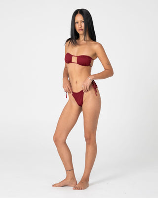woman-wearing-cedar-bandeau-open-front-bikini-top-in-cranberry