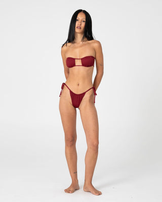 Woman wearing Cedar Bandeau Open Front Bikini Top in Cranberry