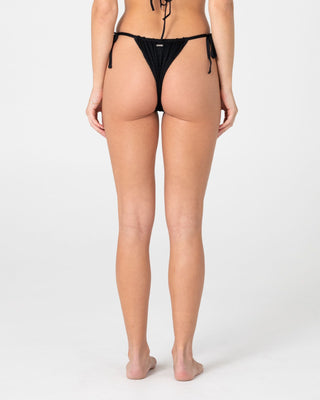 Woman wearing Cedar Cheeky Side Ties Bikini Bottom in Black