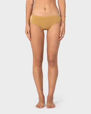 Woman wearing Shimmy Cheeky Bikini Short in Gold