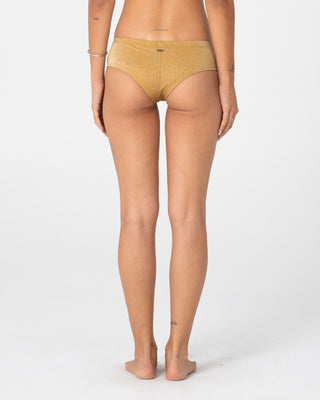 Woman wearing Shimmy Cheeky Bikini Short in Gold