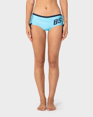 Woman wearing Stardom Booty Bikini Bottom in Navy / Aqua