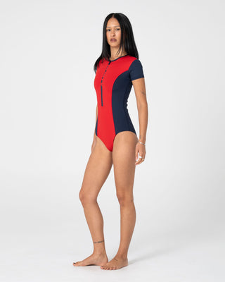 Woman wearing Dirt Rider S/S Surf Suit in Red / Navy