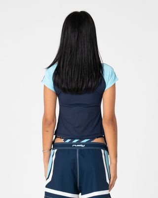 Woman wearing Mel Sea S/S Zip Through Rash Vest in Navy / Aqua