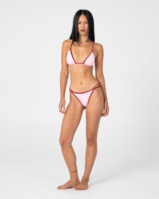 Woman wearing Sugary Brazilian Bikini Bottom in Pink / Red