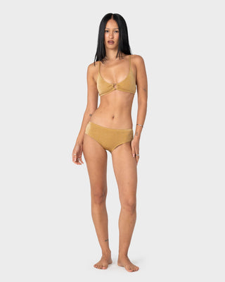 Woman wearing Shimmy Scoop Bikini Top in Gold