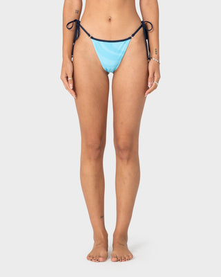 Woman wearing Stardom Cheeky Side Tie Bottom in Navy / Aqua
