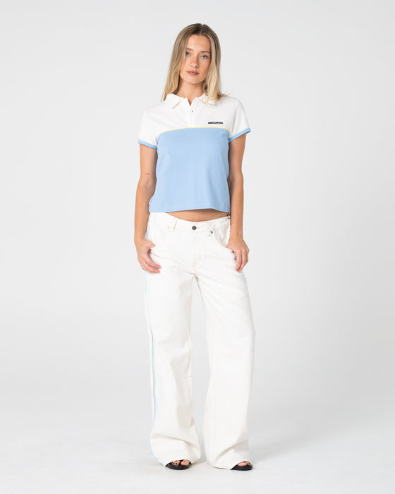 woman-wearing-insert-dad-joke-baby-polo-tee-in-retro-blue-white