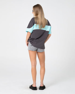 Woman wearing Kinetic Oversize Tee in Carbon / Aqua