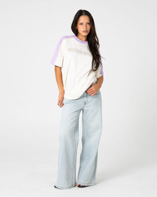 Woman wearing Timmy Target 220 Oversize Tee in Cream / Mulberry Purple