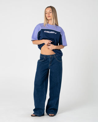 Woman wearing Archived Ops Oversize Short Sleeve Tee in Navy / Mulberry Purple