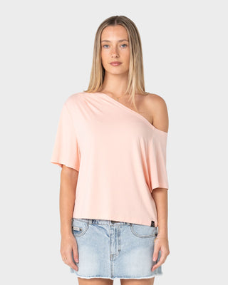 Woman wearing Sally Slouch Off Shoulder Tee in Peach Pink