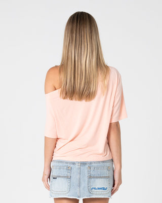 Woman wearing Sally Slouch Off Shoulder Tee in Peach Pink