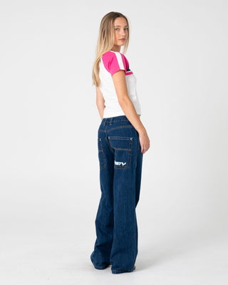 Woman wearing Raise The Ford Baby Tee in Egret / Pink