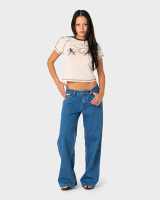 Woman wearing Double Devil Raglan Baby Tee in Cream / Java