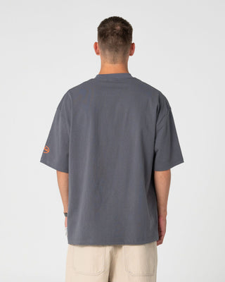 Man wearing Outliner Short Sleeve Tee in Steel