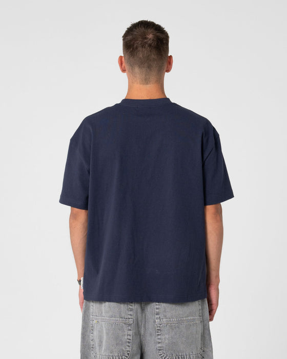 man-wearing-spray-n-pray-short-sleeve-tee-in-dark-blue