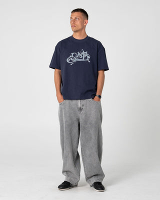 Man wearing Spray N Pray Short Sleeve Tee in Dark Blue