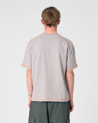 Man wearing Gridlock Short Sleeve Tee in Stone Grey