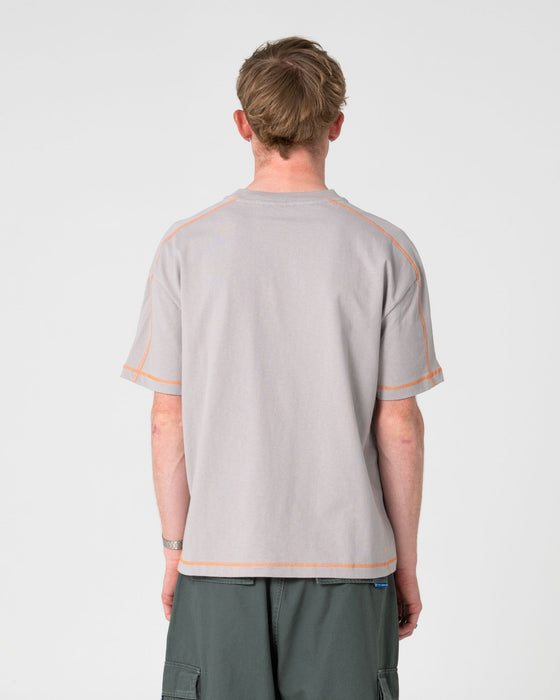 man-wearing-gridlock-short-sleeve-tee-in-stone-grey