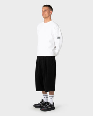 Man wearing Enigma Pleated Short in Black
