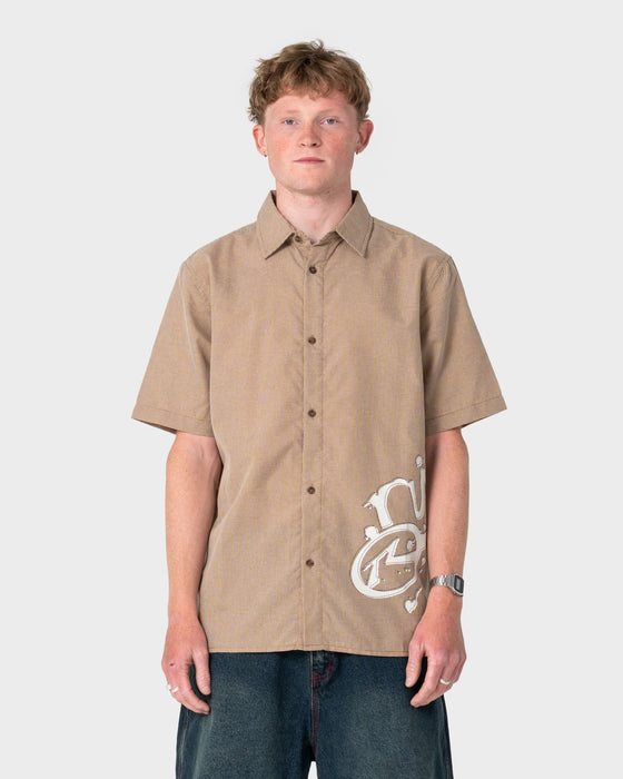 man-wearing-spray-n-pray-short-sleeve-shirt-in-pinecone