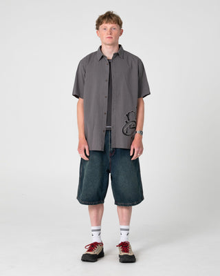 Man wearing Spray N Pray Short Sleeve Shirt in Steel