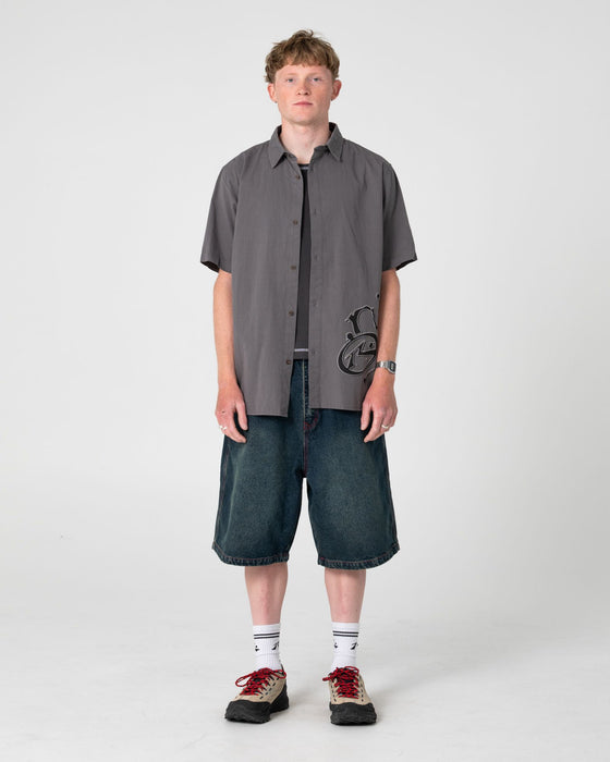 man-wearing-spray-n-pray-short-sleeve-shirt-in-steel