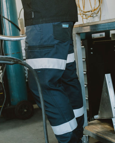 Man wearing Tr246r 9 Pkt Stretch Cuff Pant Reflect in True Navy