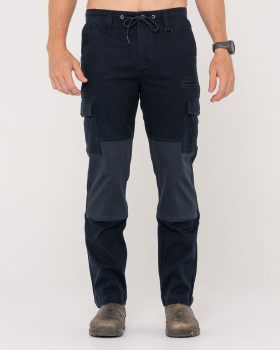 man-wearing-obligation-cargo-pant-in-navy-blue