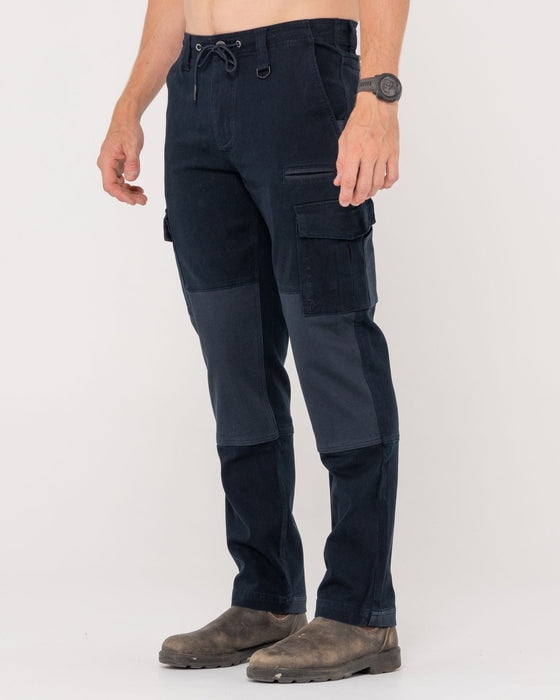 man-wearing-obligation-cargo-pant-in-navy-blue