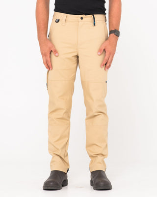 Man wearing Tr245 9 Pocket Stretch Work Pant in Trade Khaki