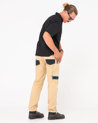Man wearing Tr245 9 Pocket Stretch Work Pant in Trade Khaki