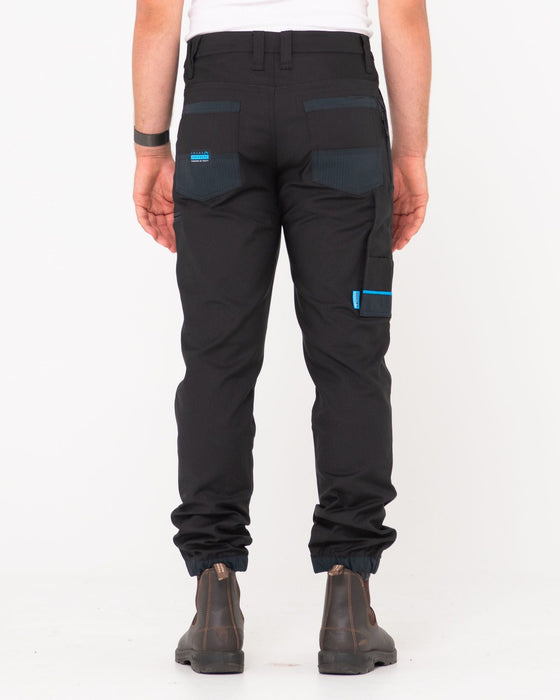 man-wearing-tr246-9-pocket-stretch-work-pant-cuffed-in-black