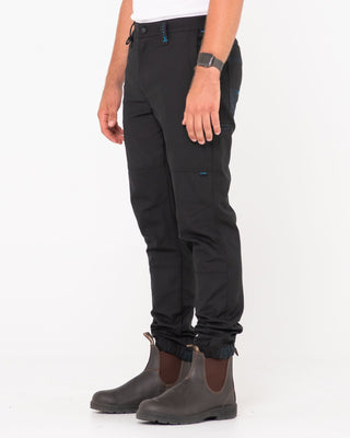 Man wearing Tr246 9 Pocket Stretch Work Pant Cuffed in Black