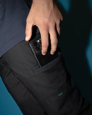 Man wearing Tr246 9 Pocket Stretch Work Pant Cuffed in Black